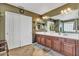 Bathroom features a double vanity with wood cabinets, and a large mirror above at 29740 W Fairmount Ave, Buckeye, AZ 85396