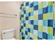 Bathroom features a toilet and blue, green and white checkered shower curtain at 29740 W Fairmount Ave, Buckeye, AZ 85396