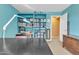 Bright bedroom features a ceiling fan, blue walls and built in shelves for storage at 29740 W Fairmount Ave, Buckeye, AZ 85396