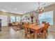 Inviting dining area blends into the living space with a large table, cozy sofas, and ample natural light at 29740 W Fairmount Ave, Buckeye, AZ 85396