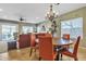 Dining area with chandelier, seamlessly connects to a spacious living room, creating an inviting and open living space at 29740 W Fairmount Ave, Buckeye, AZ 85396