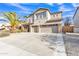 Two story stucco home with a three car garage, desert landscaping, and a large palm tree at 29740 W Fairmount Ave, Buckeye, AZ 85396