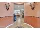 Inviting foyer entryway leading to the staircase, features stylish archway and views to the dining area at 29740 W Fairmount Ave, Buckeye, AZ 85396