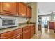 Well-appointed kitchen with wooden cabinetry, countertop appliances, and seamless transition into the adjacent rooms at 29740 W Fairmount Ave, Buckeye, AZ 85396