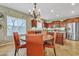 Kitchen area featuring stainless appliances, wooden cabinets and seamlessly blends into the dining area with decorative chandelier at 29740 W Fairmount Ave, Buckeye, AZ 85396