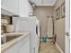 Bright laundry room features modern washer and dryer and a sink, nice and clean at 29740 W Fairmount Ave, Buckeye, AZ 85396