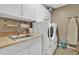 Laundry room features modern washer and dryer and a sink, nice and bright at 29740 W Fairmount Ave, Buckeye, AZ 85396