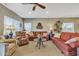 Comfortable living room with a ceiling fan, patterned seating arrangements, and warm natural light creating inviting space at 29740 W Fairmount Ave, Buckeye, AZ 85396