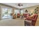 Cozy living room featuring ample seating and a sliding glass door leading to the inviting outdoor pool area at 29740 W Fairmount Ave, Buckeye, AZ 85396