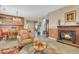 Cozy living room with a fireplace and view into the dining area creating an inviting space at 29740 W Fairmount Ave, Buckeye, AZ 85396