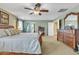 Large main bedroom featuring a king bed, ample closet space and a ceiling fan at 29740 W Fairmount Ave, Buckeye, AZ 85396