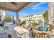 Inviting covered patio with wicker furniture overlooks the sparkling pool at 29740 W Fairmount Ave, Buckeye, AZ 85396