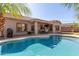 Resort style backyard oasis featuring a pool, covered patio and mature landscaping at 3034 E Coconino Dr, Gilbert, AZ 85298