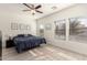 Bedroom with ceiling fan, natural light, and modern flooring at 3034 E Coconino Dr, Gilbert, AZ 85298