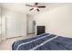 Spacious bedroom with light wood floors, ceiling fan, and closet at 3034 E Coconino Dr, Gilbert, AZ 85298