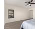 Neutral bedroom with a ceiling fan, large window, and modern flooring at 3034 E Coconino Dr, Gilbert, AZ 85298