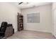 Neutral bedroom with a light wood floor, ceiling fan, window, and built-in bookshelf at 3034 E Coconino Dr, Gilbert, AZ 85298