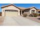 Inviting one-story home featuring a two-car garage, desert landscaping, and a charming front entry with a tile roof at 3034 E Coconino Dr, Gilbert, AZ 85298