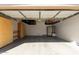 A well-lit two car garage with epoxy floors and overhead storage racks at 3034 E Coconino Dr, Gilbert, AZ 85298