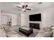 Open-concept living area with a ceiling fan, a large television, comfortable seating, and neutral-colored walls and flooring at 3034 E Coconino Dr, Gilbert, AZ 85298