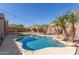 An inviting private pool with desert landscaping and rock waterfall features at 3034 E Coconino Dr, Gilbert, AZ 85298