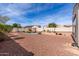 Expansive backyard with a shimmering pool, desert landscaping, and hardscape create a serene outdoor space at 30488 N 126Th Dr, Peoria, AZ 85383