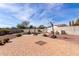 Expansive backyard featuring a pool, mature desert landscaping, and a basketball hoop for outdoor enjoyment at 30488 N 126Th Dr, Peoria, AZ 85383