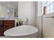 Bright bathroom with a freestanding tub and stylish vanity showcases a clean and modern aesthetic at 30488 N 126Th Dr, Peoria, AZ 85383