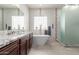 Beautiful bathroom featuring a soaking tub, a walk-in shower, and double sink vanity with granite countertops at 30488 N 126Th Dr, Peoria, AZ 85383