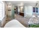 Expansive bathroom boasts a luxurious soaking tub, dual vanities, a separate shower room, and elegant tiling at 30488 N 126Th Dr, Peoria, AZ 85383