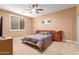 Well-lit bedroom featuring a ceiling fan, neutral tones, and contemporary furniture at 30488 N 126Th Dr, Peoria, AZ 85383