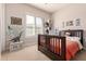 Cozy bedroom with a dark wood bed, a window with shutters, and dinosaur-themed decor at 30488 N 126Th Dr, Peoria, AZ 85383