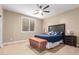 Comfortable bedroom with a ceiling fan, a window and a chest at the foot of the bed at 30488 N 126Th Dr, Peoria, AZ 85383