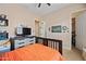Cozy bedroom with orange bedding, tv on dresser and closet view at 30488 N 126Th Dr, Peoria, AZ 85383