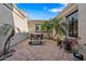 Private courtyard featuring brick paving, mature landscaping, and comfortable outdoor seating, ideal for entertaining at 30488 N 126Th Dr, Peoria, AZ 85383