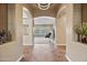 Welcoming entryway with tile flooring, arched doorways, and elegant decor, leading into a spacious living area at 30488 N 126Th Dr, Peoria, AZ 85383
