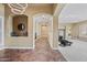 Inviting entryway with stylish tile flooring, arched openings, and tasteful decor, flowing into a bright living space at 30488 N 126Th Dr, Peoria, AZ 85383