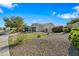 Single-story home with desert landscaping, a large driveway, and a two-car garage, surrounded by mature trees at 30488 N 126Th Dr, Peoria, AZ 85383