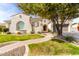 Charming stucco home showcasing mature landscaping, a brick walkway, and a two-car garage at 30488 N 126Th Dr, Peoria, AZ 85383