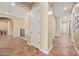Hallway view featuring neutral walls, tiled floors, and multiple entryways to different rooms at 30488 N 126Th Dr, Peoria, AZ 85383