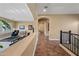 Hallway view showing an open floor plan with arched entryways and tile flooring throughout at 30488 N 126Th Dr, Peoria, AZ 85383