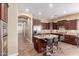 Gourmet kitchen featuring an island with seating and lots of storage in the dark wood cabinets at 30488 N 126Th Dr, Peoria, AZ 85383