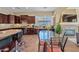 Spacious kitchen featuring dark wood cabinetry, granite countertops, and a large central island with barstool seating at 30488 N 126Th Dr, Peoria, AZ 85383