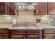 Gourmet kitchen featuring a stainless steel stovetop and granite countertops at 30488 N 126Th Dr, Peoria, AZ 85383
