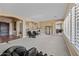Large living room with plush carpeting, ample natural light, and open layout for entertaining at 30488 N 126Th Dr, Peoria, AZ 85383