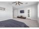 Large main bedroom featuring light gray walls, neutral carpet, and a wall-mounted television at 30488 N 126Th Dr, Peoria, AZ 85383