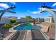 Lovely inground pool, brick pavers, and sun loungers, creating a serene backyard oasis under a clear blue sky at 30488 N 126Th Dr, Peoria, AZ 85383
