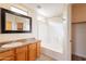 Clean bathroom featuring a shower-tub combo, vanity with sink, and a large mirror at 320 N 168Th Dr, Goodyear, AZ 85338