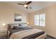 Comfortable bedroom with neutral tones, a ceiling fan, and a window for natural light at 320 N 168Th Dr, Goodyear, AZ 85338