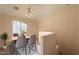 Elegant dining room with modern furnishings and natural light from the window at 320 N 168Th Dr, Goodyear, AZ 85338